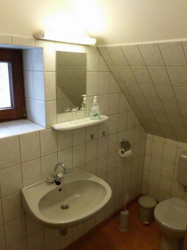 a bathroom with a sink and a toilet at Gästezimmer mit Garten - b59462 in Werneuchen