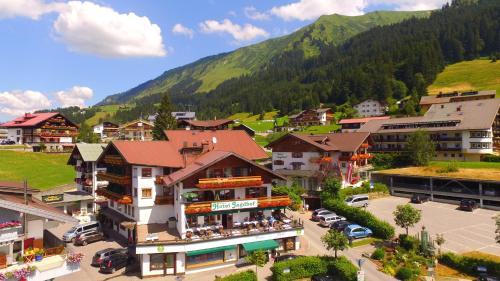 an aerial view of a town with a mountain at Hotel Jagdhof in Riezlern