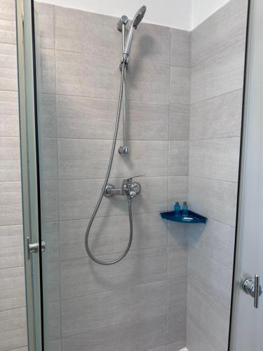 a shower with a shower head in a bathroom at Diamant residence - self check in & free parking in Bragadiru