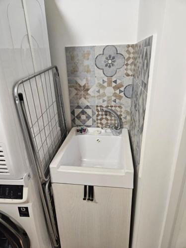 a bathroom with a white sink in a rv at Santalucia Apartment in Modugno