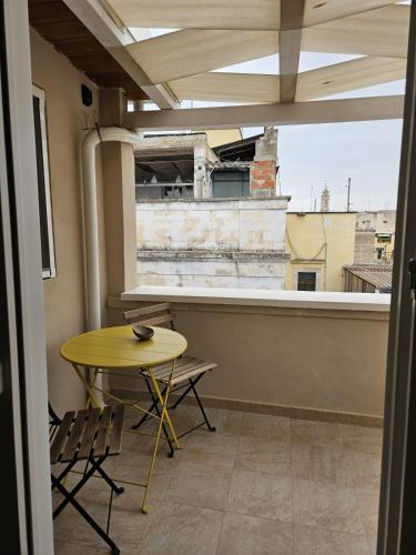 a table and chairs in a room with a window at Santalucia Apartment in Modugno