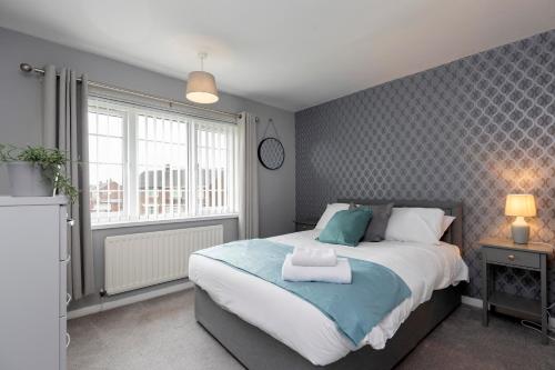 a bedroom with a large bed and a window at Park Green in Stockton-on-Tees