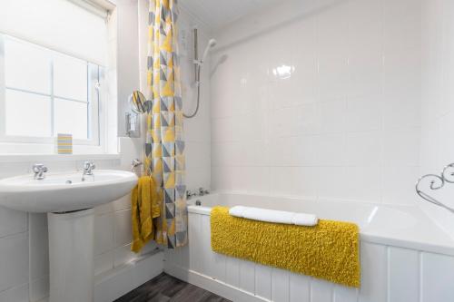 a white bathroom with a sink and a bath tub at Park Green in Stockton-on-Tees