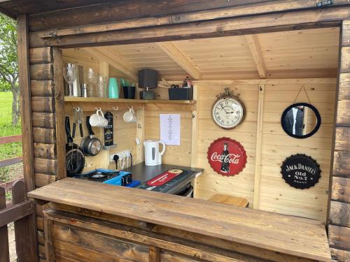 a kitchen with a stove in a wooden cabin at Little Bunny Retreat in Bradmore