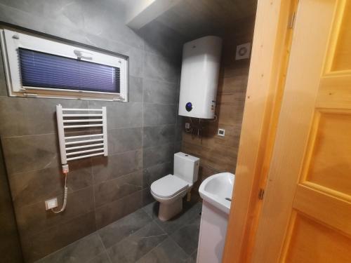 a small bathroom with a toilet and a window at Energy4YOU Zator in Zator