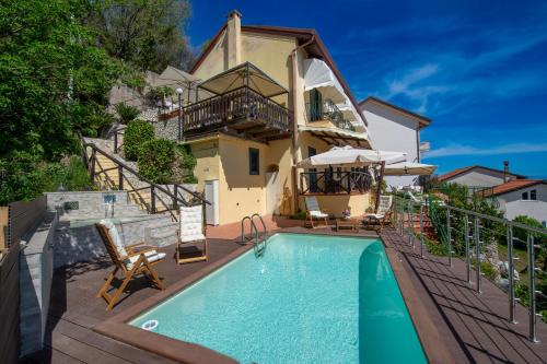 a villa with a swimming pool in front of a house at Solaria in Amalfi
