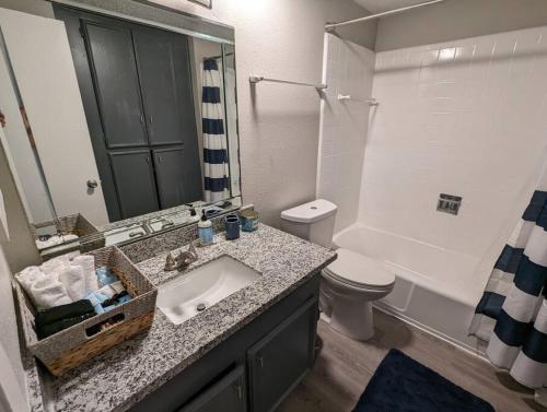 a bathroom with a sink and a toilet at The Space Mariner in Houston