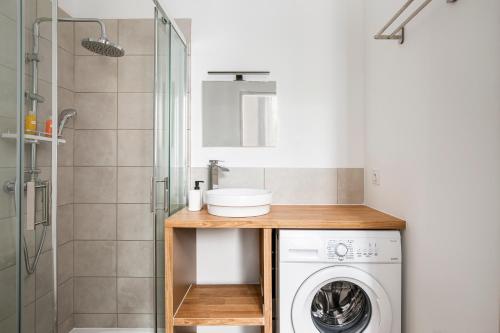 La salle de bains est pourvue d'un lave-linge et d'une douche. dans l'établissement Nationale 101 CahorsCityStay, à Cahors
