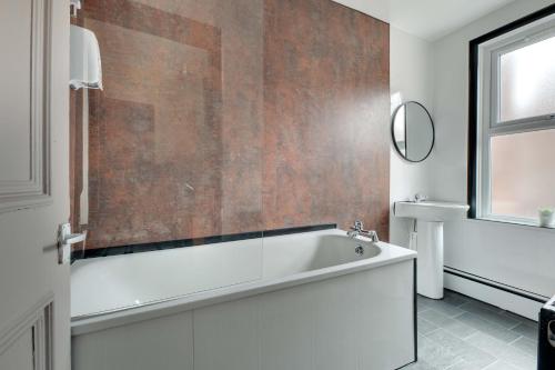 a bathroom with a bath tub and a sink at Newcastle CITY Apartments 5 in Newcastle upon Tyne