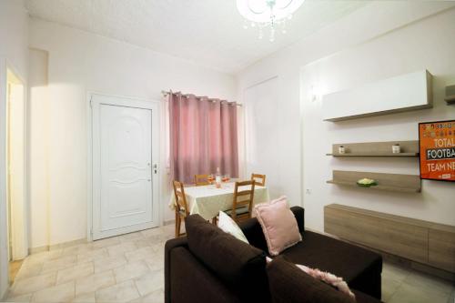 a living room with a couch and a table at Amaryllis Boutique Apartments in Moraitika