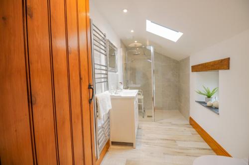 a bathroom with a sink and a shower at Torties Cottage in Brampton