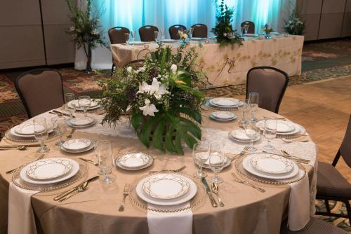 a table with plates and glasses and a vase of flowers at Holiday Inn Estes Park by IHG in Estes Park