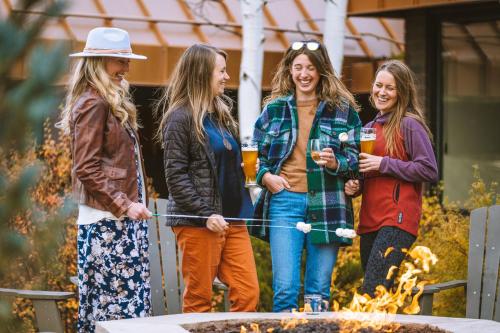 a group of women standing around a fire at Holiday Inn Estes Park by IHG in Estes Park