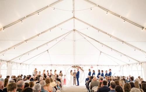 a wedding ceremony in a white tent at Holiday Inn Estes Park by IHG in Estes Park