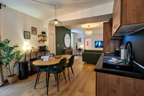 a kitchen and living room with a table and chairs at Le Oliva chez les M by Primo Conciergerie in Nevers