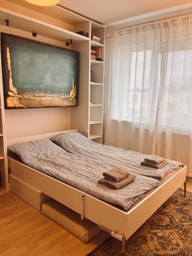 a bed with two towels on it in a bedroom at Lorand's Place near the River in Cluj-Napoca