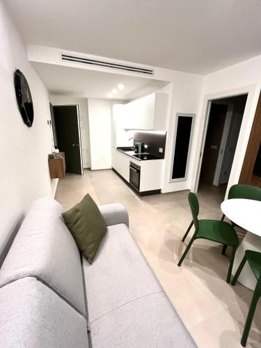 a living room with a white couch and a table at Seacity Suite & Stay in Monopoli