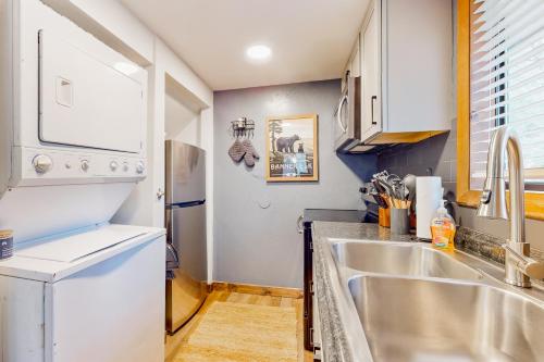 a kitchen with a sink and a refrigerator at 30A Creekside in Banner Elk