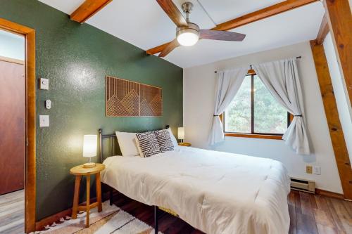 a bedroom with a bed and a green wall at 30A Creekside in Banner Elk