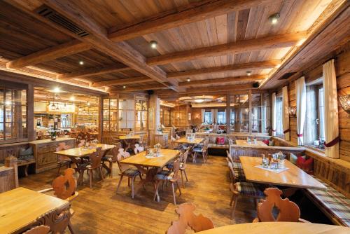 a restaurant with wooden floors and tables and chairs at Wellness-Hotel ADLER in Bad Wörishofen