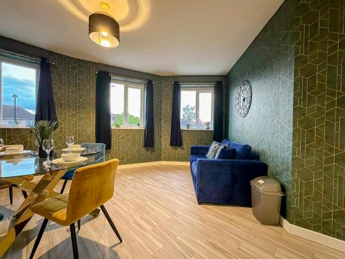 a living room with a blue couch and a table at Luxury Boutique Apartments Block Free Street Parking in Hounslow