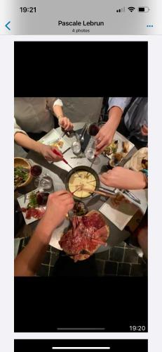 a group of people sitting around a table eating food at Miss cocotte champêtre in Gesves