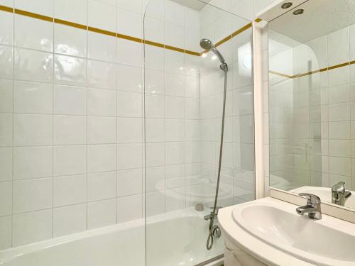 a bathroom with a shower and a tub and a sink at Appartement Flumet, 2 pièces, 4 personnes - FR-1-505-206 in Flumet