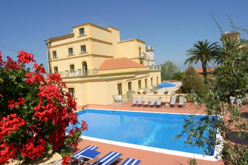 a large house with a swimming pool in front of it at Hotel Villa Igea in Sorrento