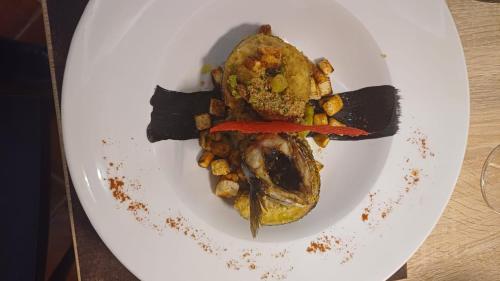 a white plate with a meal of food on it at B&B Del Centro e SPA in Partinico