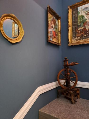 a blue room with a mirror and a wooden wheel at Accommodation Zara in Vukovar