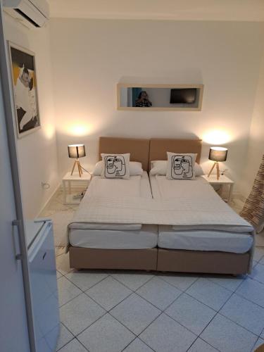 a bedroom with a large bed and two lamps at Accommodation Zara in Vukovar