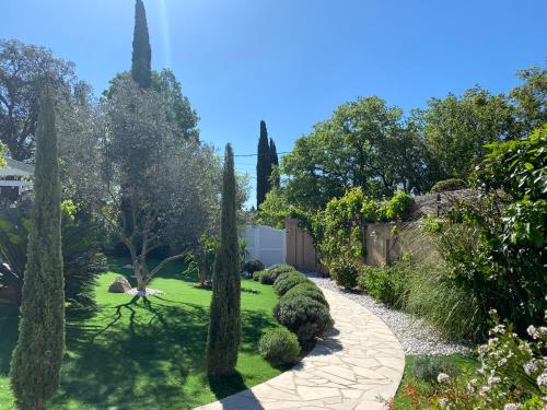 a garden with trees and a walkway at La Roca Flora in Plan-de-la-Tour