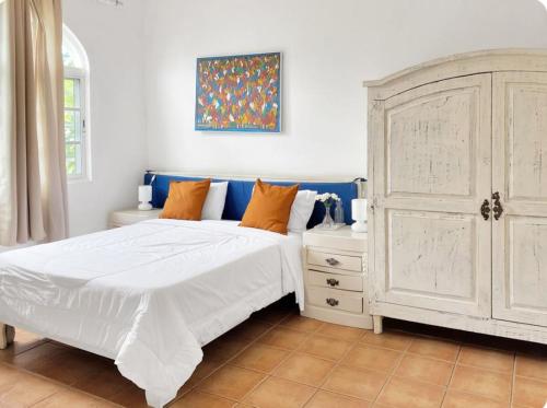 een slaapkamer met een wit bed en een witte kast bij Castillo 1 in Santo Domingo