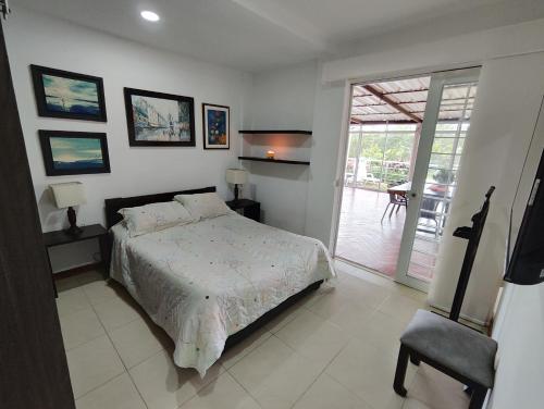 a bedroom with a bed and a sliding glass door at Orion Luxury Lodge in Calibío