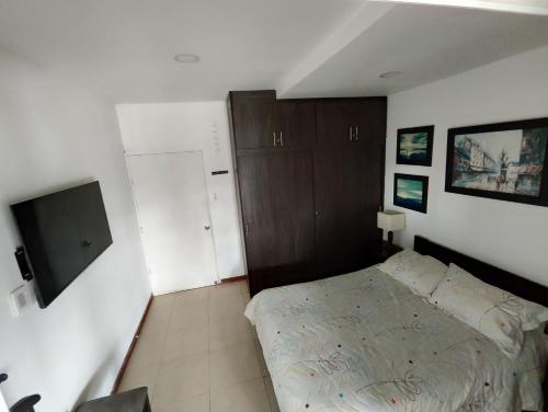 a small bedroom with a bed and a cabinet at Orion Luxury Lodge in Calibío