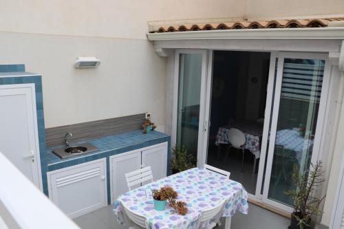 Elle comprend un balcon avec une table et un lavabo sur la terrasse. dans l'établissement Lavanda, à Marina di Ragusa