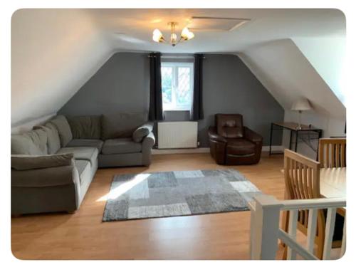 a living room with a couch and a chair at The Little House, Oswestry in Chirk