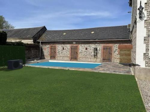 a swimming pool in the backyard of a house at Villa de 4 chambres avec piscine privee sauna et jardin clos a La Poterie Cap d'Antifer in La Poterie-Cap-dʼAntifer