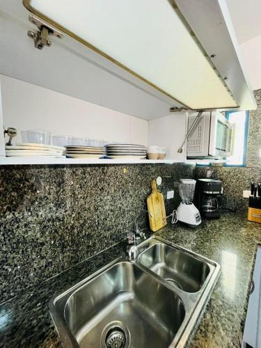a kitchen with a sink and a counter top at Casas de Corintia en playa Moreno isla Margarita in Pampatar