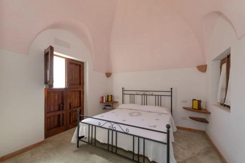 Postel nebo postele na pokoji v ubytování Dammuso Tramonto