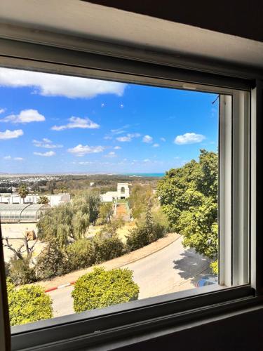 an open window with a view of a street at Duplex in La Marsa