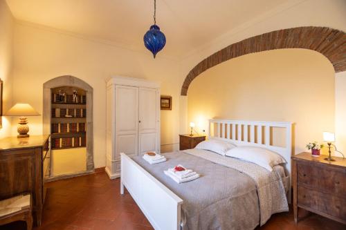 a bedroom with a large bed with two towels on it at Villa Medici Donnini in Arezzo