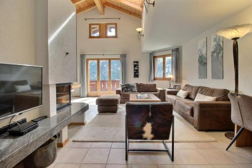 a living room with a large flat screen tv at Mossettes 5, Penthouse Sunny Terrasse And Sauna in Champéry