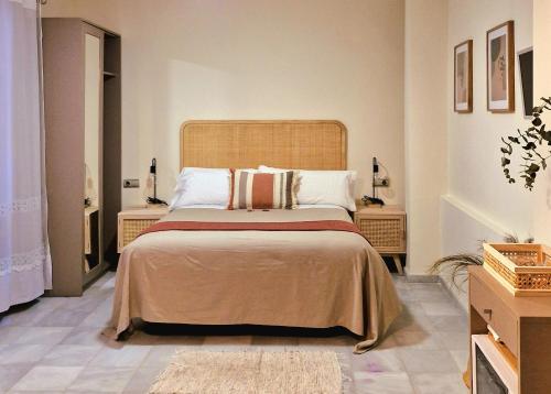a bedroom with a large bed and two night stands at Apartamentos VITA CENTER in Granada