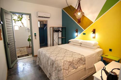 a bedroom with a bed and a yellow wall at Pefkos Eye in Pefki Rhodes