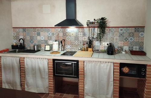 a kitchen with a sink and a stove top oven at Vivienda Rural Ronda in Aldeaquemada