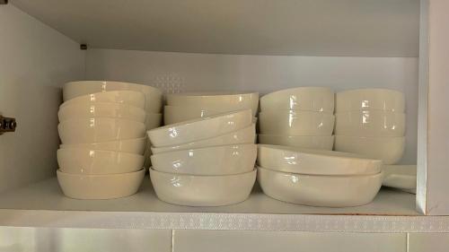a bunch of white bowls sitting on a shelf at Ansik in Busan