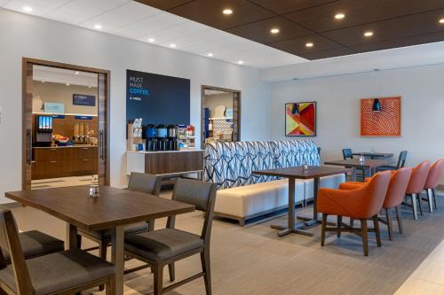 a restaurant with tables and chairs and a bench at Holiday Inn Express & Suites St Thomas in Saint Thomas