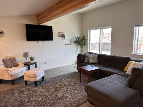 a living room with a couch and a flat screen tv at The Asbury House Guest Rentals in Moscow