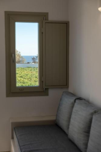 a window in a room with a couch and a mirror at Windmillside Luxury Villas in Emporio Santorini
